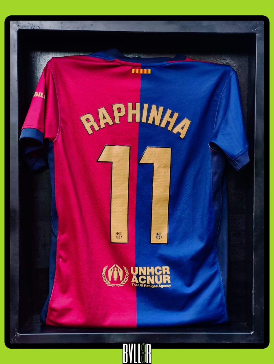 Raphinha Barcelona 2024/25 home kit displayed in BVLL3R's premium acrylic case with hologram highlights, featuring club crest, Spotify sponsor, and signature number 11.